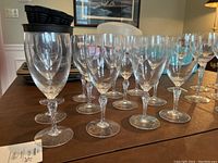 Set of 12 Lenox Aria water glasses arranged on a table showing clear glass and twisted faceted stems.