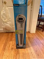 Full view of the Holmes Whole Room Tower Fan boxed in retail packaging standing upright on floor.