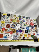 Top view of the collection of vintage pinback buttons from the 1970s to 1990s, showing various colors and designs.