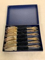 Six antique sterling silver dessert forks arranged in original blue box with black velvet holders