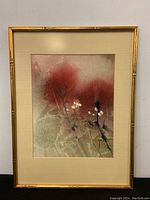 Full view of framed watercolor artwork with bamboo-style golden frame, cream mat, and abstract floral design in red, green, and white.