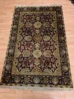 Full view of the entire carpet showing the overall pattern and colors. Carpet lies flat on a wood floor.