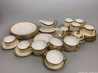 Angled view showing dinner plates, gravy boat, covered sugar bowl, mugs and saucers, teacups, soup bowls