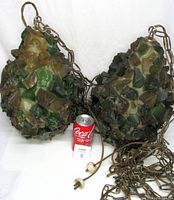 Pair of chunky lucite lamps with green, brown, amber, and cream pieces, laid on white cloth with Coca-Cola can for scale.