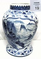 Blue and white porcelain vase showing detailed Chinese mountain and river landscape painting and floral borders