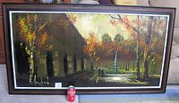 Full view of framed oil painting with soda can for scale