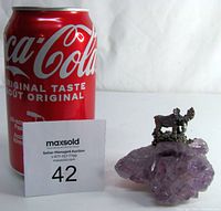 Photo showing the pewter moose figurine on an amethyst rock with a Coca-Cola can for scale.