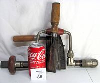 Photo showing the three vintage heavy-duty tools displayed with a Coca-Cola can for size reference. Visible items are a wooden handled chisel, Gross Stabil clamp, and manual drill.