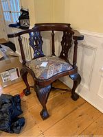 Front and side views of the dark wood corner chair with ornate carvings and upholstered seat showing condition and details.