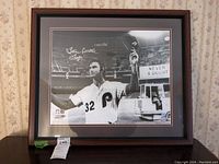 Full view of framed signed Steve Carlton black and white photo print, 22x26, showing Steve Carlton in Phillies uniform number 32, framed in a dark brown wooden frame and double matting.