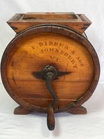 Front view of wooden barrel butter churn with hand crank and branding W.P. Ridder & Son, Johnson VT visible.