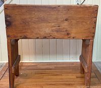 Front view of vintage wooden dough hutch showing box top and four legs