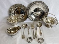 Overview of all pieces including two platters, candy dish, gravy boat, utensils and napkin rings