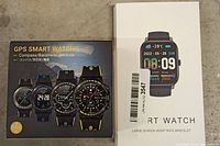 Boxes of two smart watches: one GPS smart watch with multiple features and one large screen heart rate bracelet smart watch.