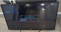 Front view of Samsung 32 inch flat screen TV powered on showing 'No Cable Connected' message on HDMI 3 input.