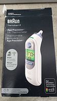 Front of the Braun ThermoScan 7 packaging showing product name, image, and highlighted features such as #1 pediatrician recommended brand, Age Precision technology.