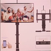 Mounted motorized TV lift with TV showing a group of people watching a basketball game, remote control user interface, and control panel with up/down and preset buttons.