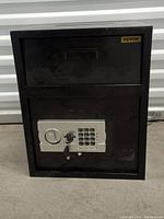 Front view of the black Vevor safe with digital keypad, key lock, handle, and small upper deposit slot.
