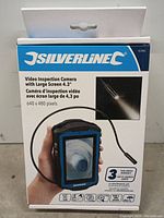 Photo of the front of the sealed factory packaging showing brand Silverline, product image, screen size, resolution and three-year warranty.