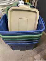 Photo of stacked plastic storage bins with lids on top showing blue, green, and tan colors, with a note indicating 5 pieces.