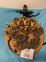 Photo of vintage brass hardware including drawer pulls and handles arranged on wooden surface