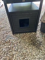 Front view showing the square cutout entrance and slatted panel design.