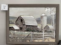Framed painting depicting a rustic barn with silo, windmill, smaller shed, and fence in muted earth tones.