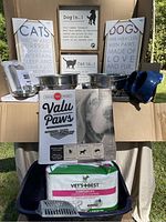 Photo showing various pet care items including stainless steel bowls, puppy pads, female dog diapers, and pet-themed wall decor signs.