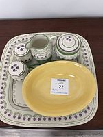 All items displayed on rectangular serving platter with floral border and green stripe accents