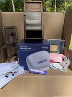 Main lot image showing washboard cabinet, ultraviolet sanitizer box, nail care items, wall hooks, and barber cape.