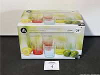 Photo showing box front with colorful image of 12 piece acrylic drinkware set including 6 highballs and 6 lowballs in bubble texture and assorted colors