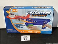 Front view of the toy box showing the product name, features, and images of the toy aircraft and hand-held launcher.