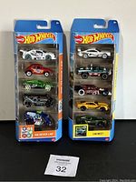 Two sealed Hot Wheels packs titled HW Design Lab and Car Meet, each containing five Hot Wheels cars, displayed front view showing packaging and cars inside.