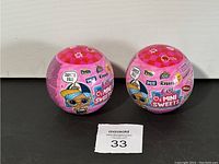 Two unopened LOL Surprise I Love Mini Sweets collectible balls showing front and back sides of the packaging.