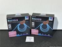 Two boxes of NeonGlo LED rope lights with specifications and branding visible.