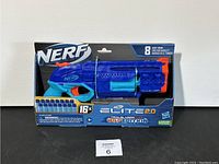 Front view of the Nerf Elite 2.0 Trailblazer RD-8 Wild Edition blaster in original packaging, showing the blue and teal blaster with orange trigger and barrel tip.