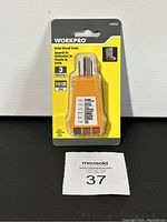 Front view of WorkPro outlet circuit tester in original packaging showing device and front labeling.