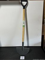 Full view of the turf edger showing wooden handle with D-shaped grip and metal blade
