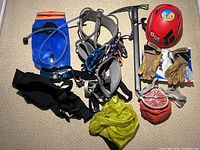 Overview of all included climbing gear items arranged on floor