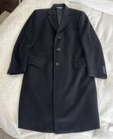 Front view of black cashmere coat laid flat showing notched lapel, three-button front, flap pockets and overall condition.
