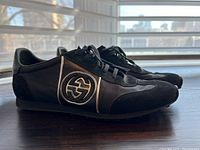 Right side view of both sneakers showing profile and silver-toned interlocking G logo