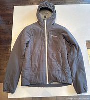 Front view of the men's grey Patagonia light insulated jacket with hood, showing white zipper, Patagonia logo on chest, and overall condition.