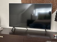 Front view of TV on stand on dresser