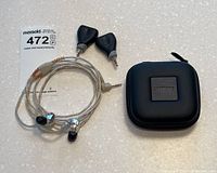 Overview of earphones laid out with adapters, splitter and case