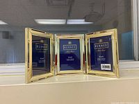 Front view of the 3-part hinged brass photo frame showing three individual frames with placeholders for 3.5x5 photos.