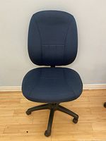 Front view of the blue padded office chair showing seat and backrest.