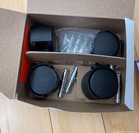 Set of 4 black replacement castor wheels for office chairs with metal installation pins displayed in box.