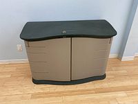 Front view of closed bin showing double-door front and padlock hasp