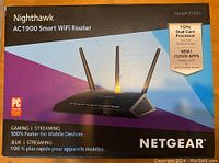 Netgear Nighthawk AC1900 R7000 WiFi Router in original box with product branding and feature highlights.