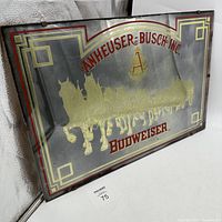 Front angled view of vintage Budweiser horses mirror beer sign showing gold horses and wagon with red Anheuser-Busch and Budweiser text on mirror reflective background